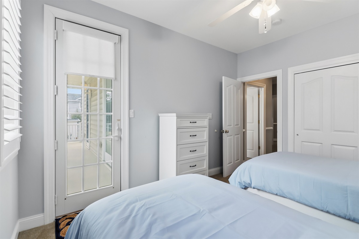 Two twin sized beds with access to shared deck