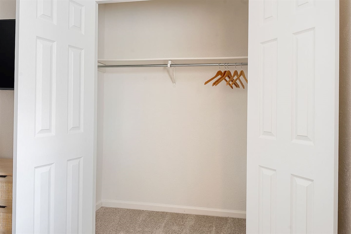 Store your belongings conveniently in this well-organized closet, providing ample space for all your essentials.
