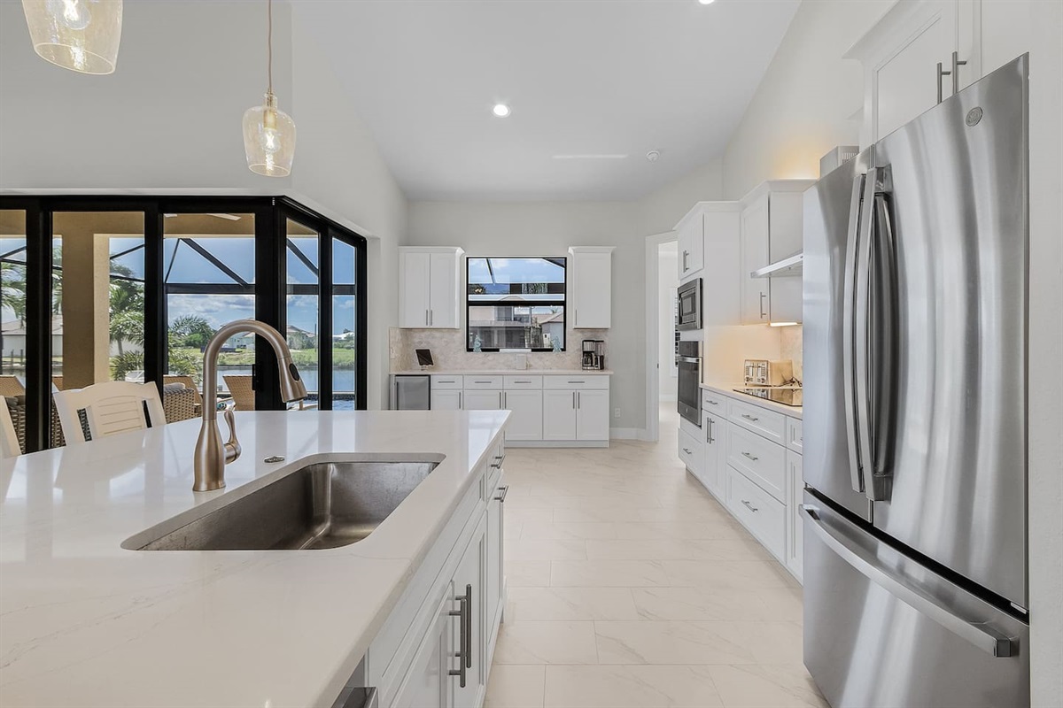 Experience a stunning kitchen adorned with stainless steel appliances, sleek quartz countertops, and ample space for culinary creations!