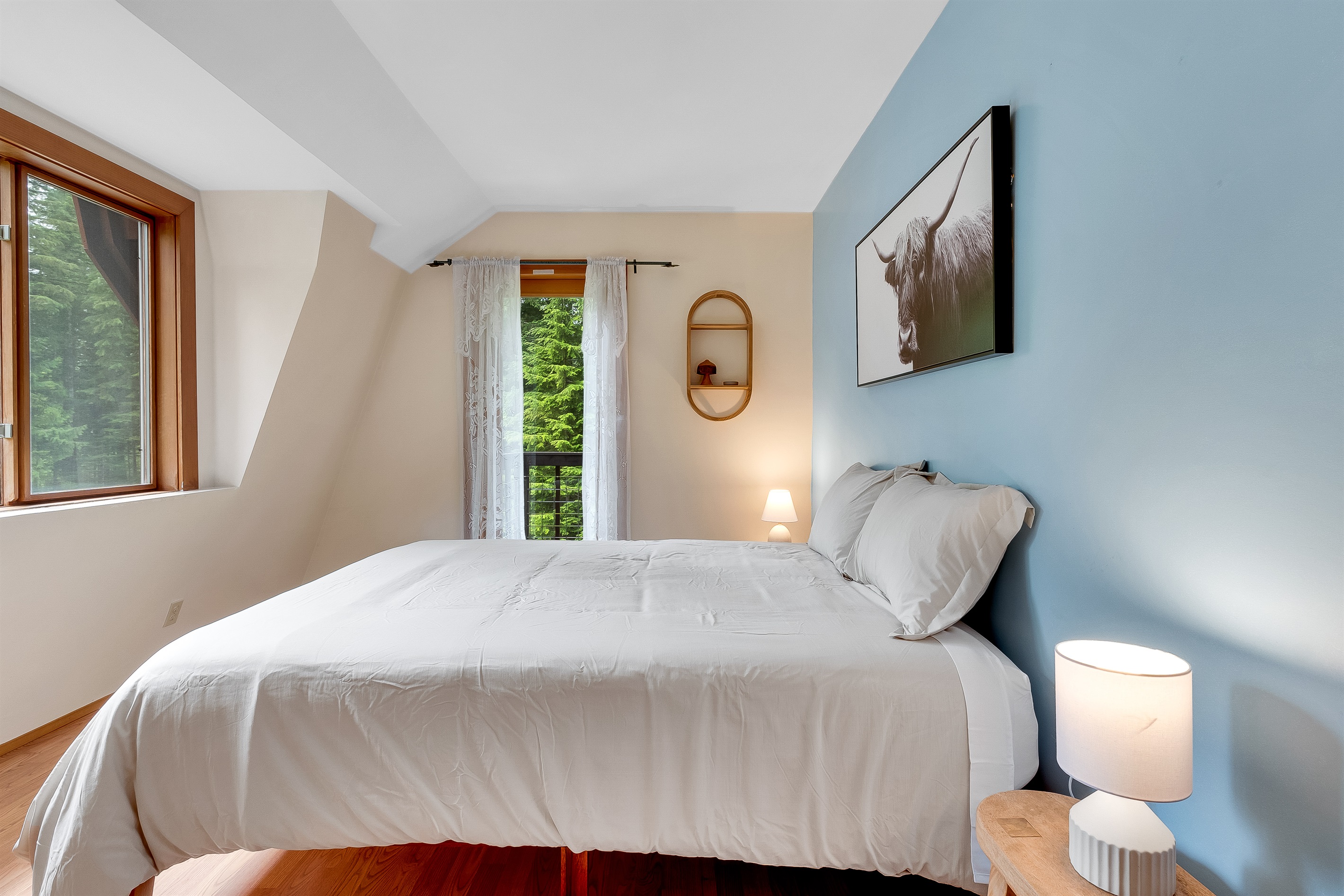 Our second upstairs bedroom comes with a cozy queen sized bed and it's own balcony