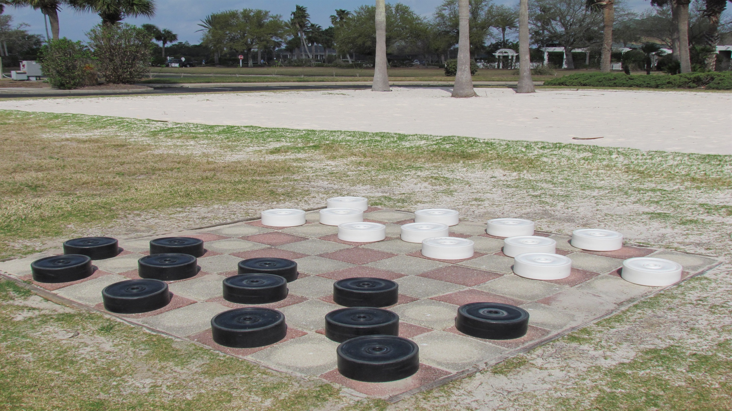 Experience the perfect blend of relaxation and recreation at The Beach Club. Our life-size checkers are waiting for you!