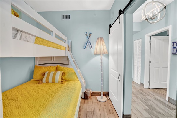 Bunk room with sliding barn door