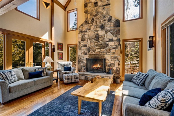 Enjoy the two story cathedral ceiling fireplace made of Door County stone. And  a live edge coffee table.