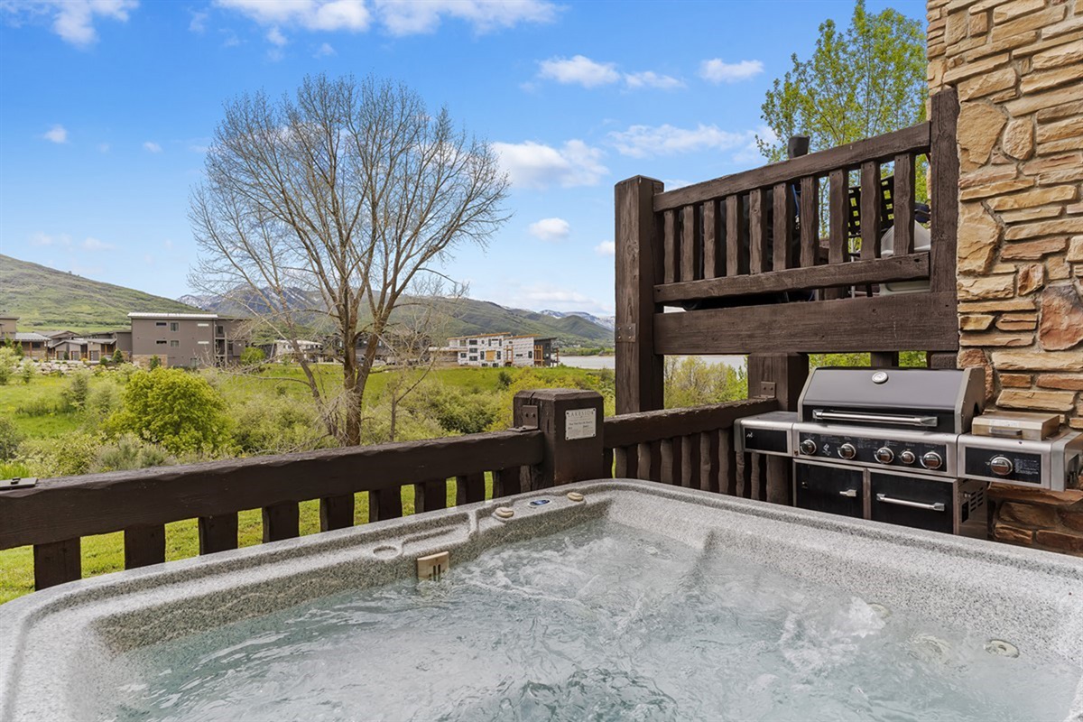Private upper deck with hot tub and grill—perfect for relaxing and dining with mountain views.