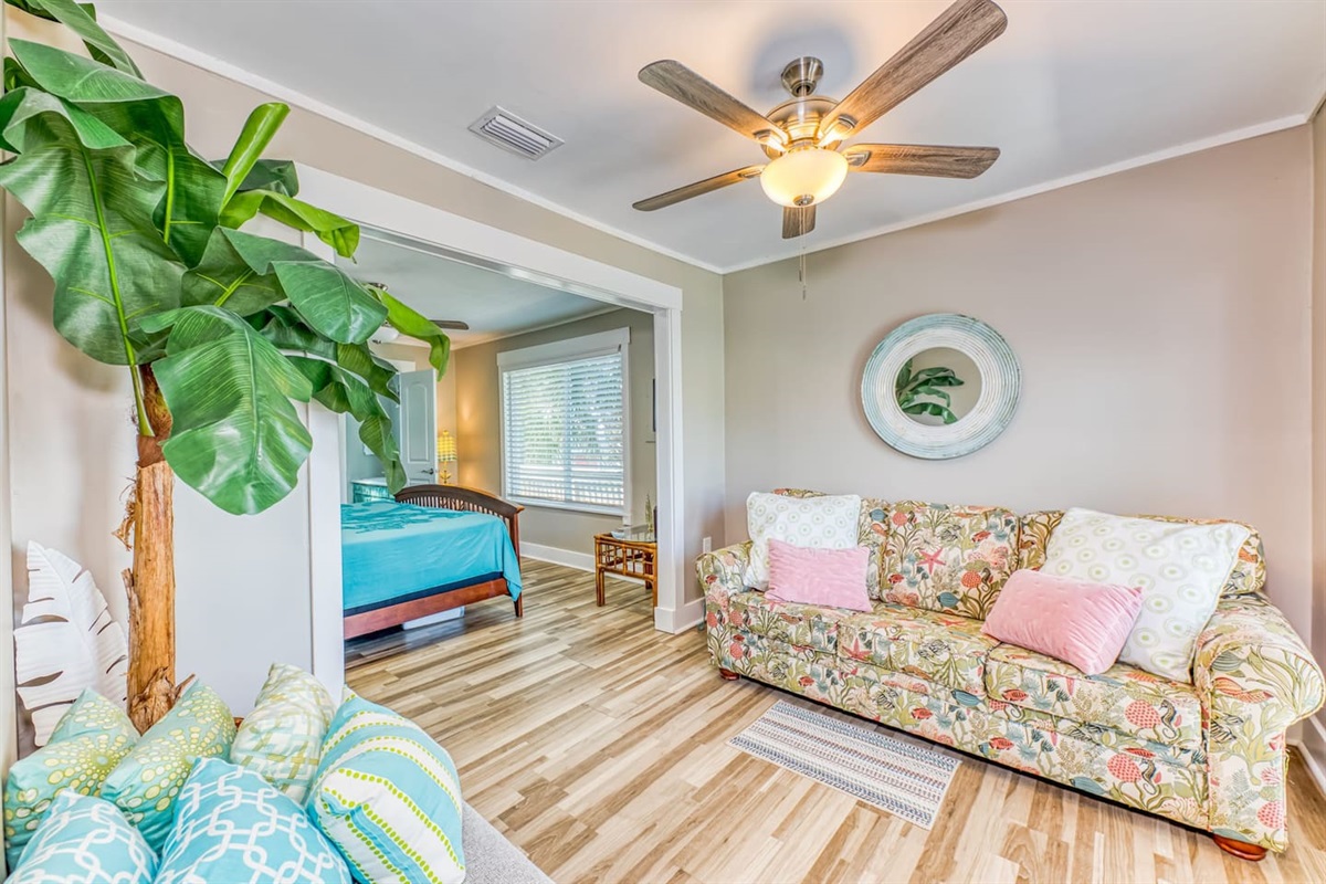 Master Bedtoom: Vibrant decor, sleeper sofa and inviting space perfect for relaxation and beachside memories!