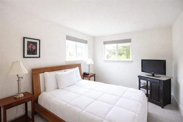 Second Bedroom: Bright and airy retreat with queen bed and flat-screen TV for ultimate relaxation!