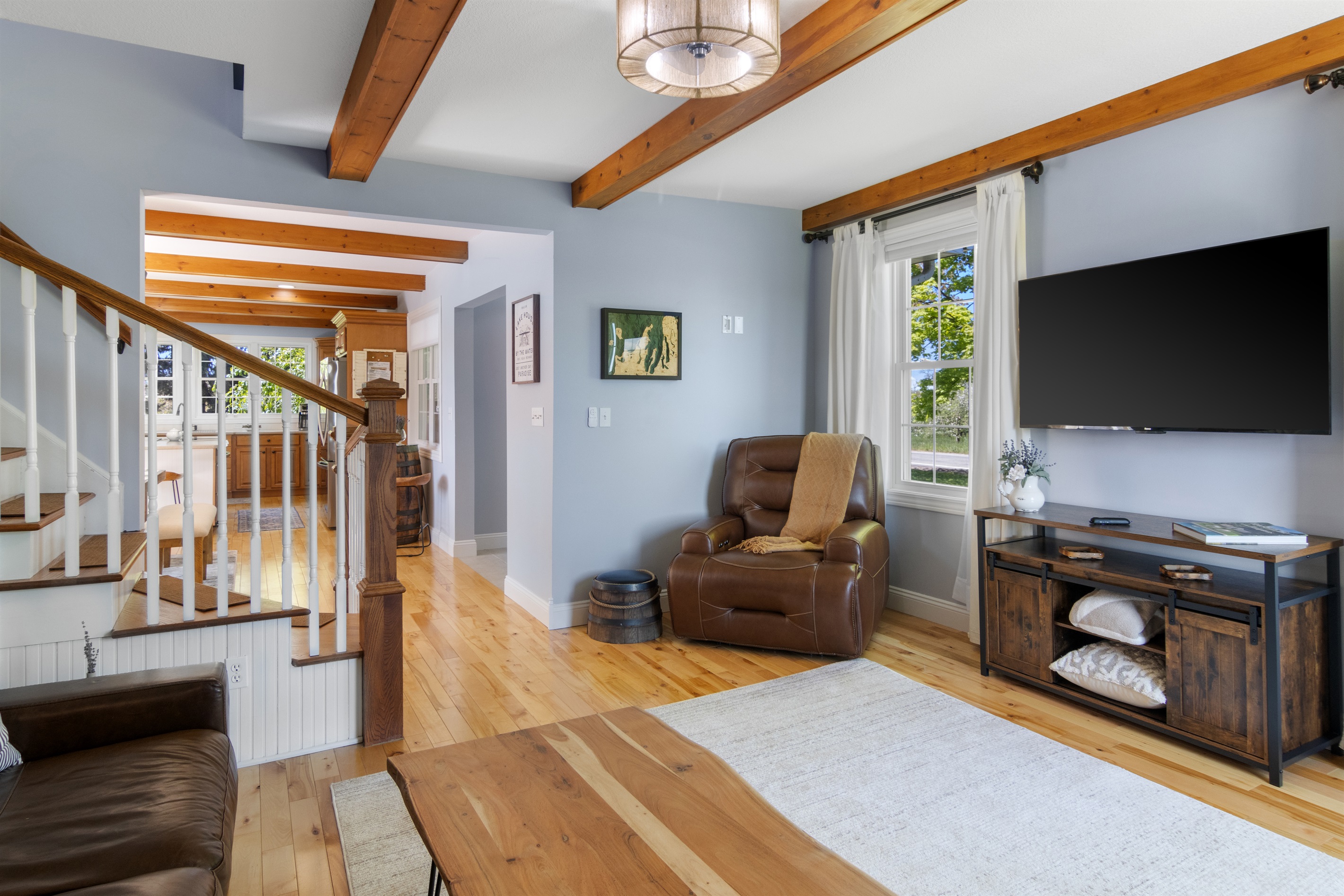 Comfortable seating area with rustic beams and natural light.
