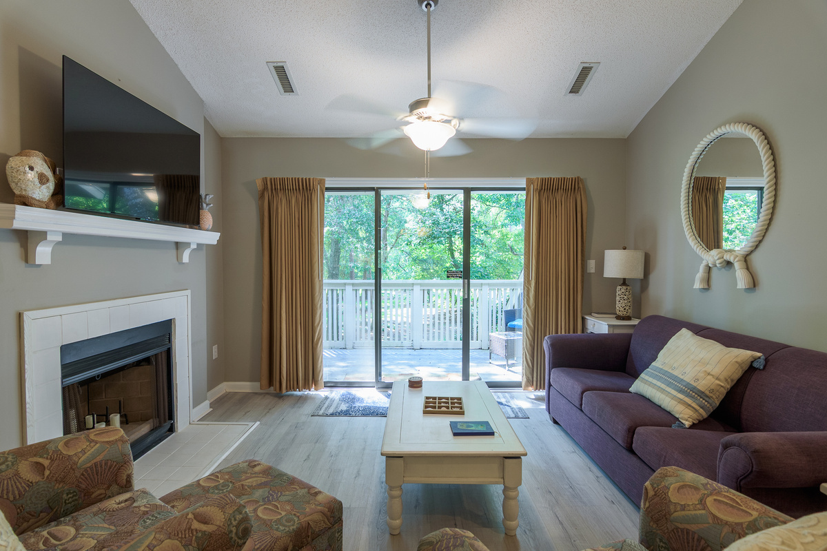Comfortable living room with large TV and deck access