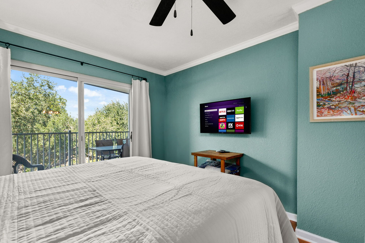 Primary bedroom with flat screen TV.