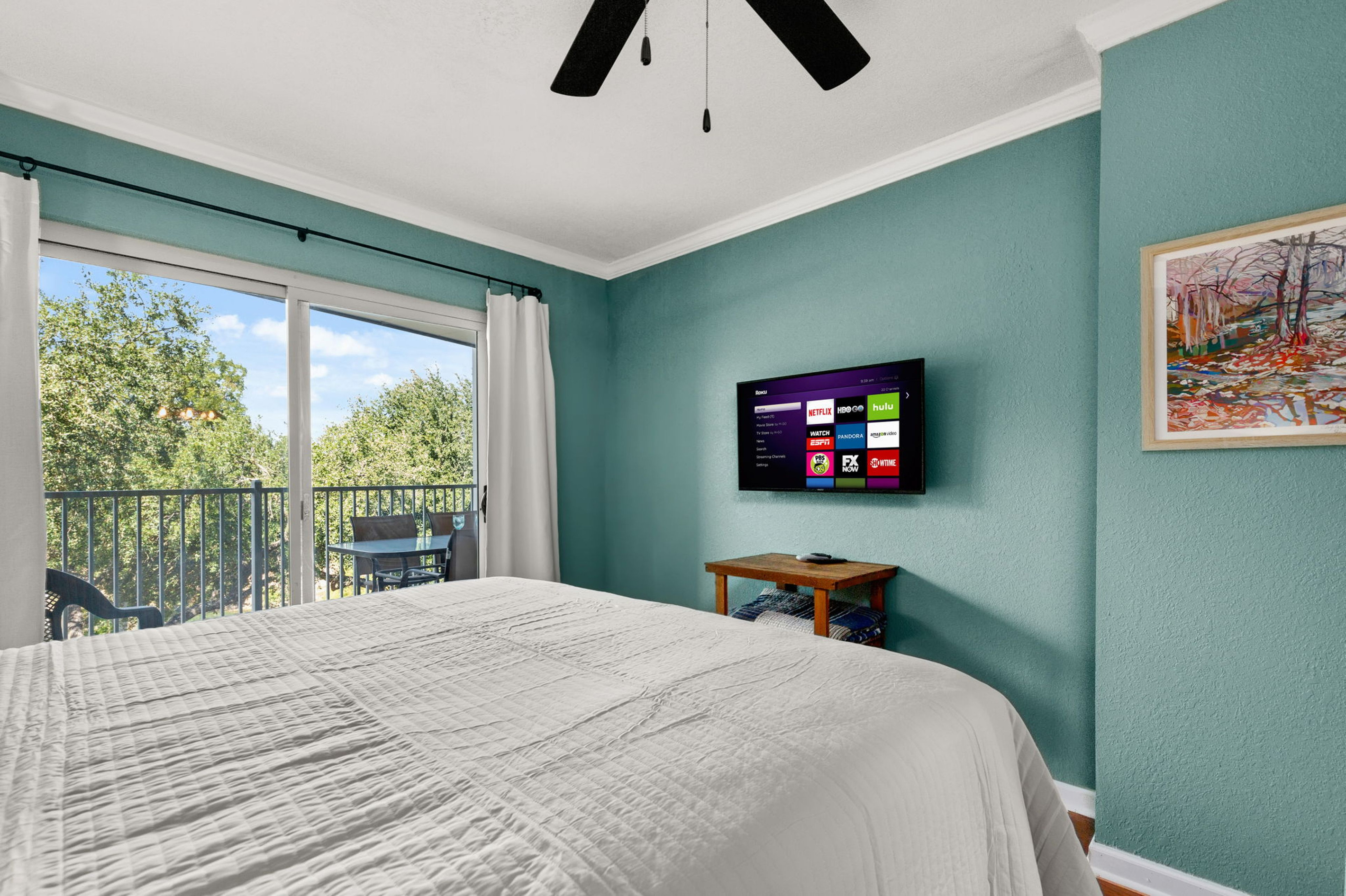 Primary bedroom with flat screen TV.