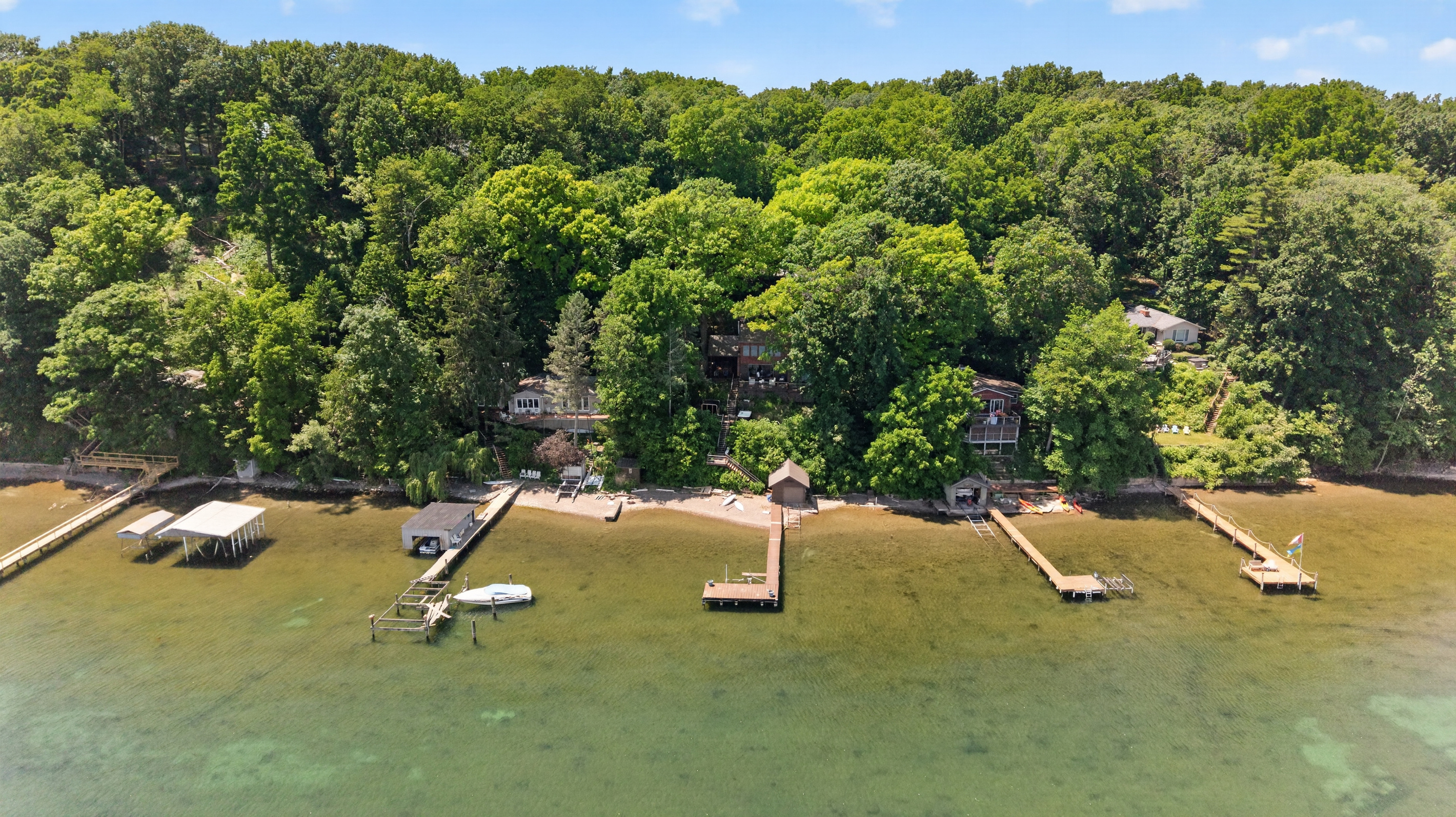 Multiple docks along the wooded shoreline