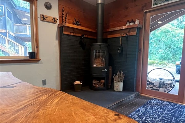 Gather around the live edge slab table for some games or a puzzle while you warm up by the Morso wood burning fireplace
