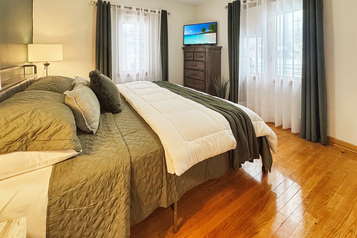 Plush King master with TV and full length mirror.