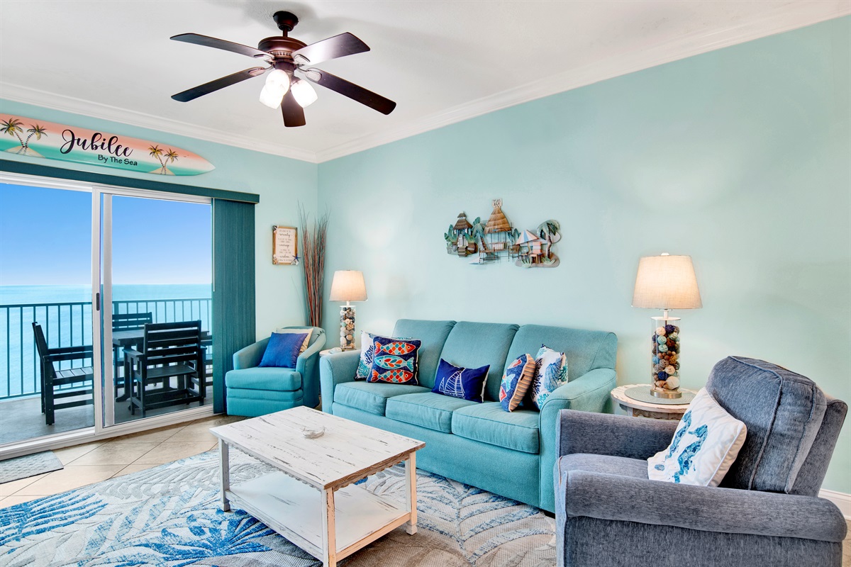 Living room sleeper sofa, 2 end tables, coffee table 2 arm chairs, ceiling fan and a 55" wall mounted Smart TV and a great direct Gulf view