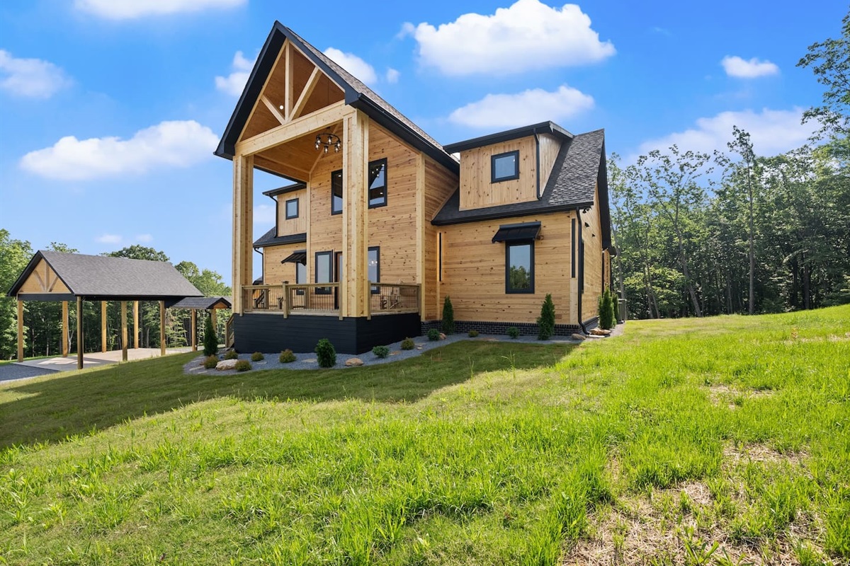 The perfect blend of rustic charm and luxury, this front corner view showcases clean lines, stone-accented landscaping, and nature all around.