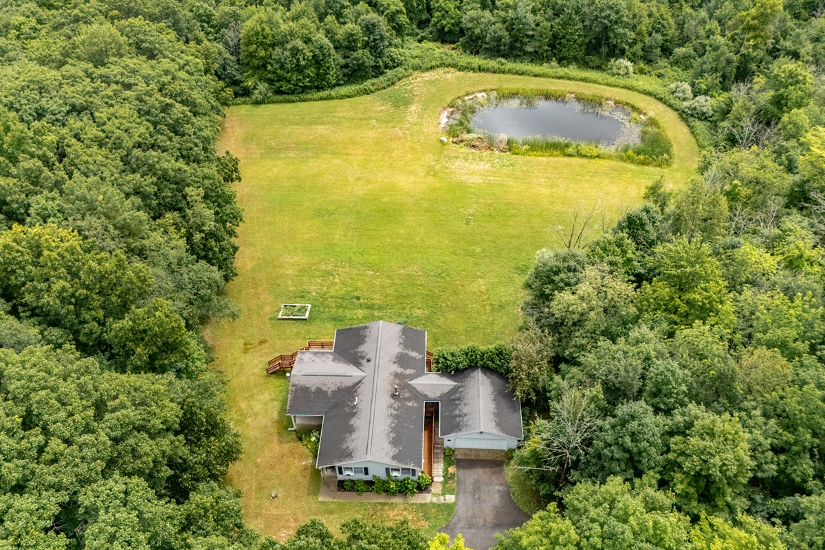 Nestled in total privacy, this charming home overlooks a lush clearing and serene private pond—your own secluded sanctuary.