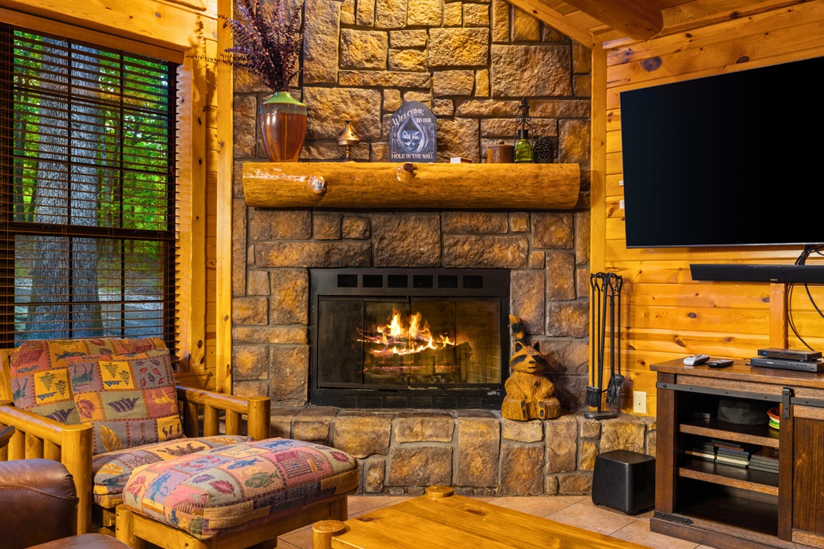 Stone fireplace and rustic seating for the coziest nights in.