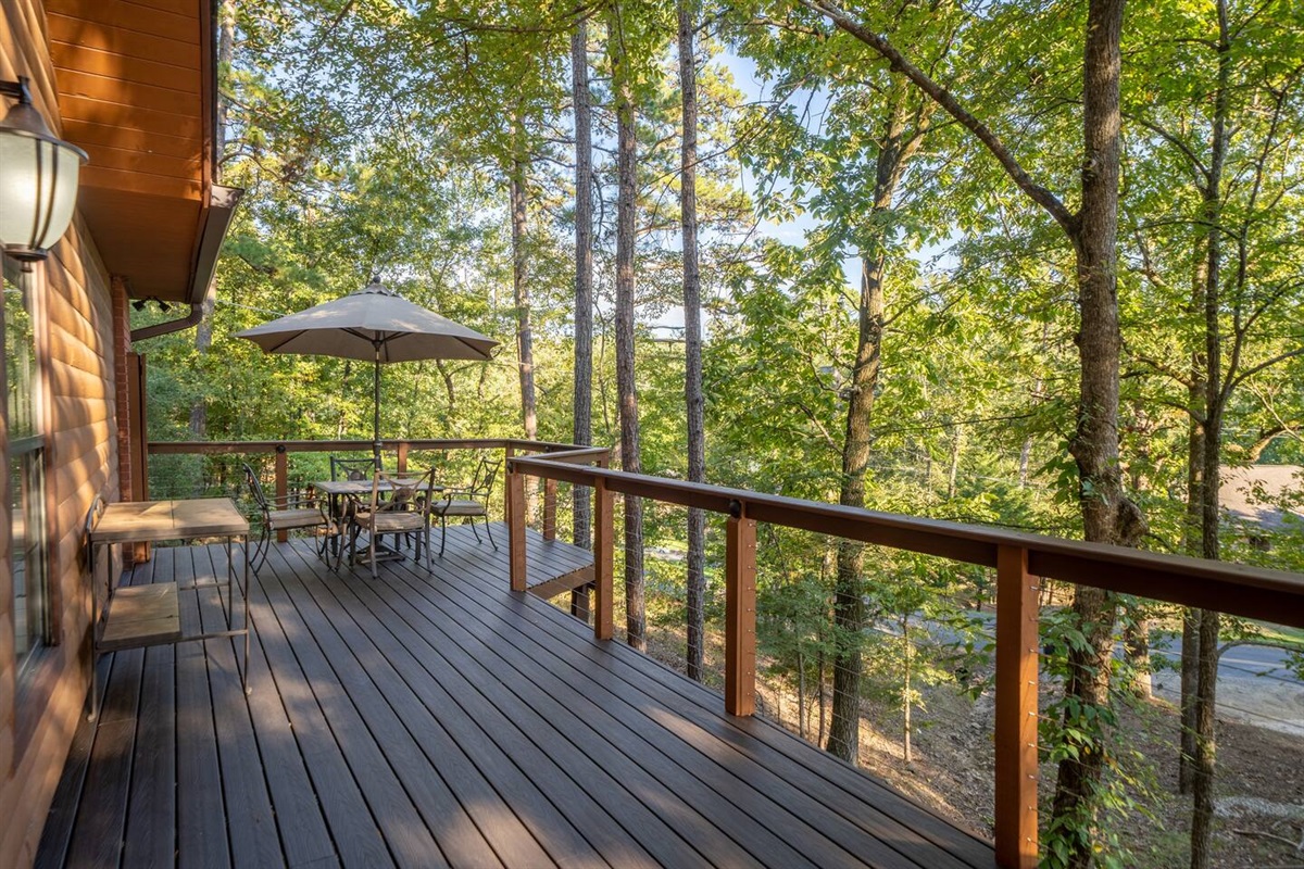 A buffet for outdoor dining, and dining table for 4.  The deck overlooks the Lake across the street  You are high up in the trees. -Front Deck
