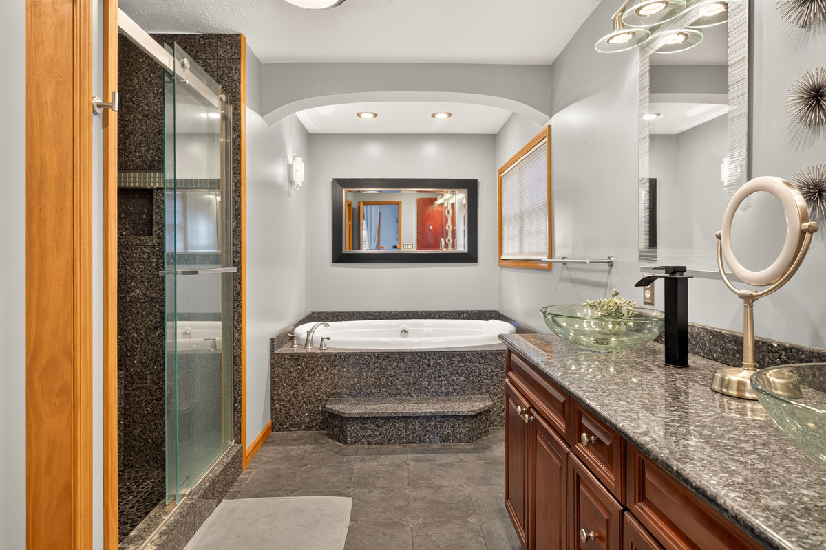 Ensuite bathroom with bathtub and double vanity