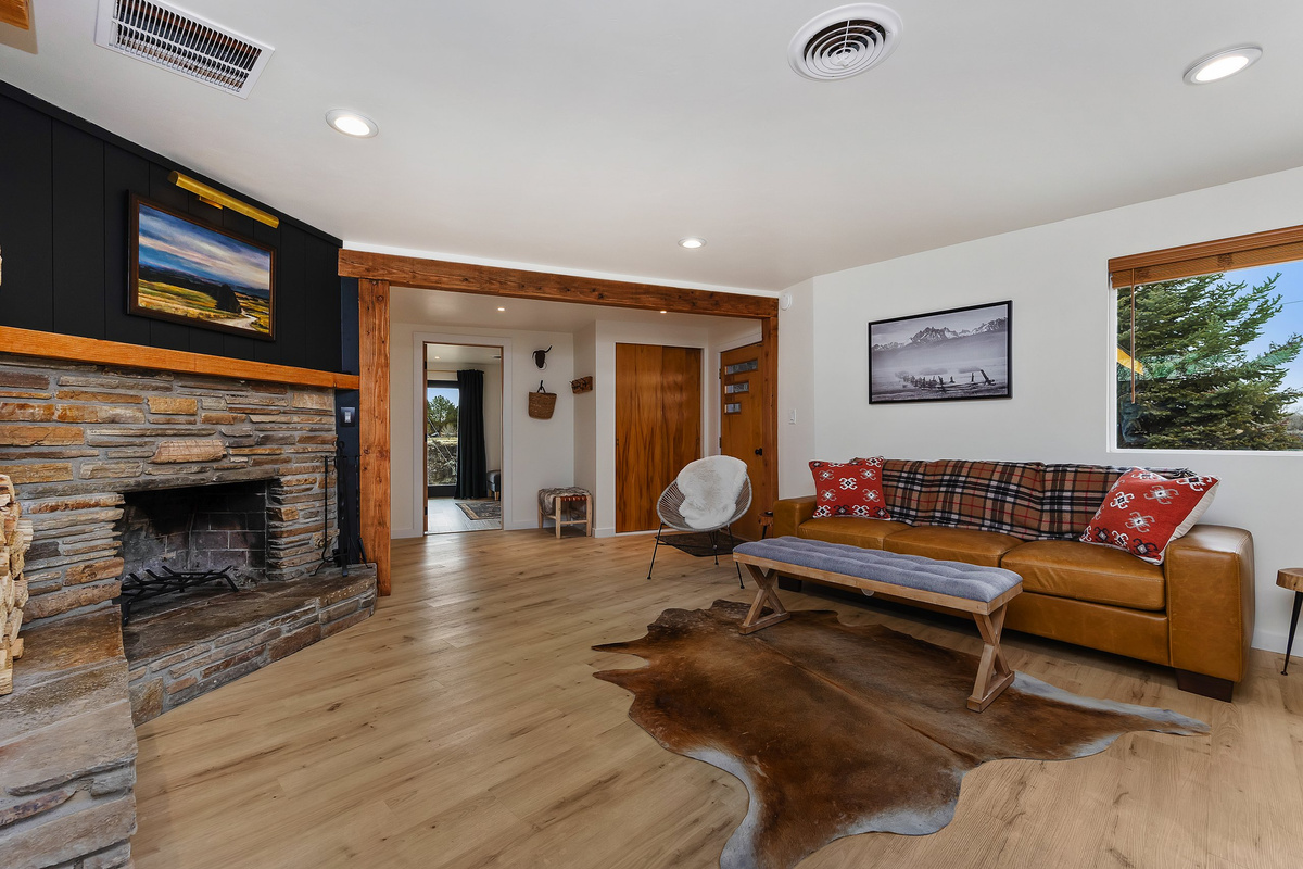 Living room with a cozy fireplace and canyon views out the windows