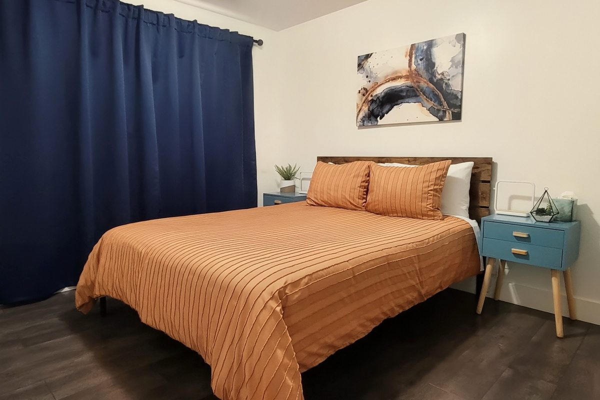 Second bedroom with blackout curtains closed.