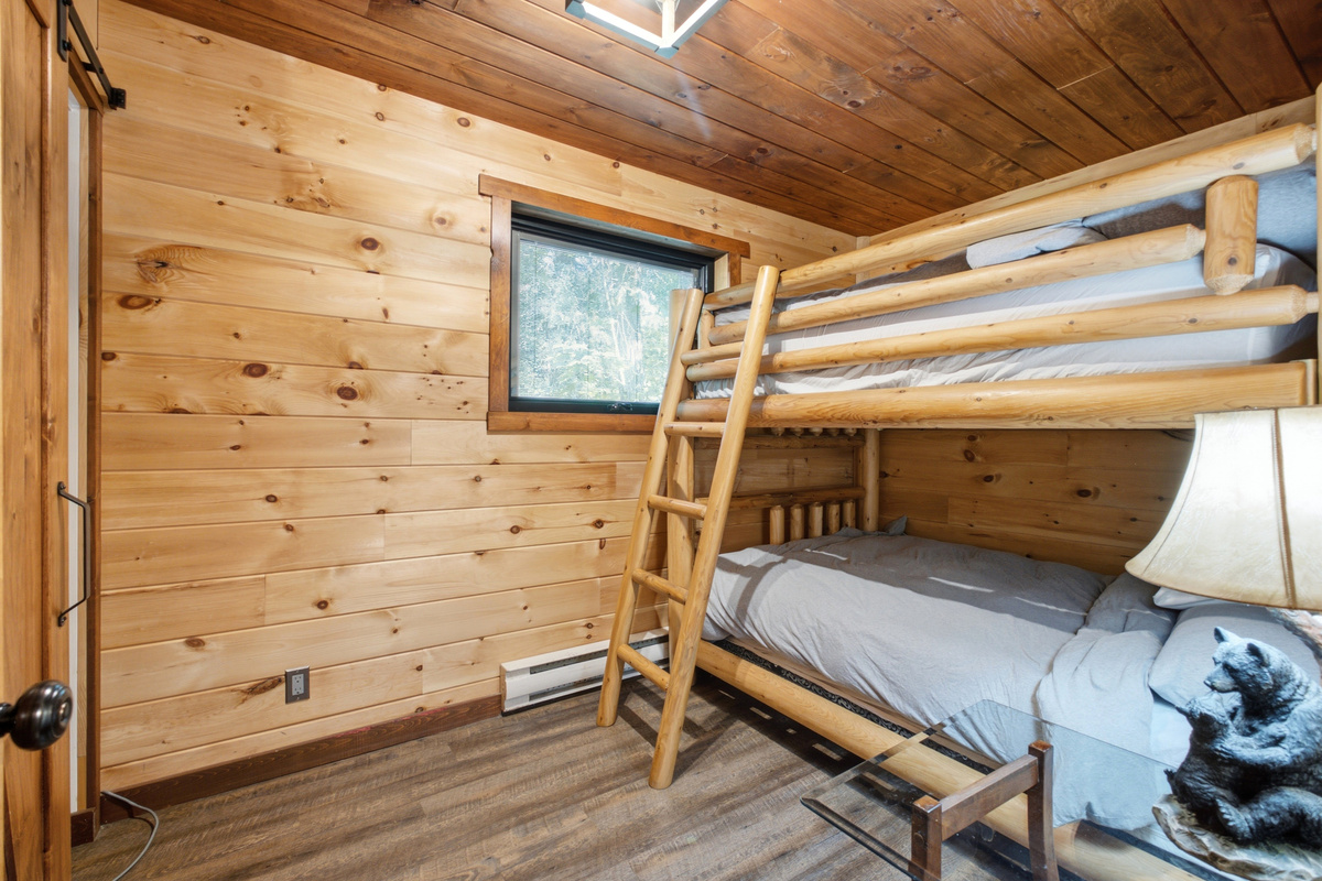 Bunk bedroom with rustic wood finishes and natural light
