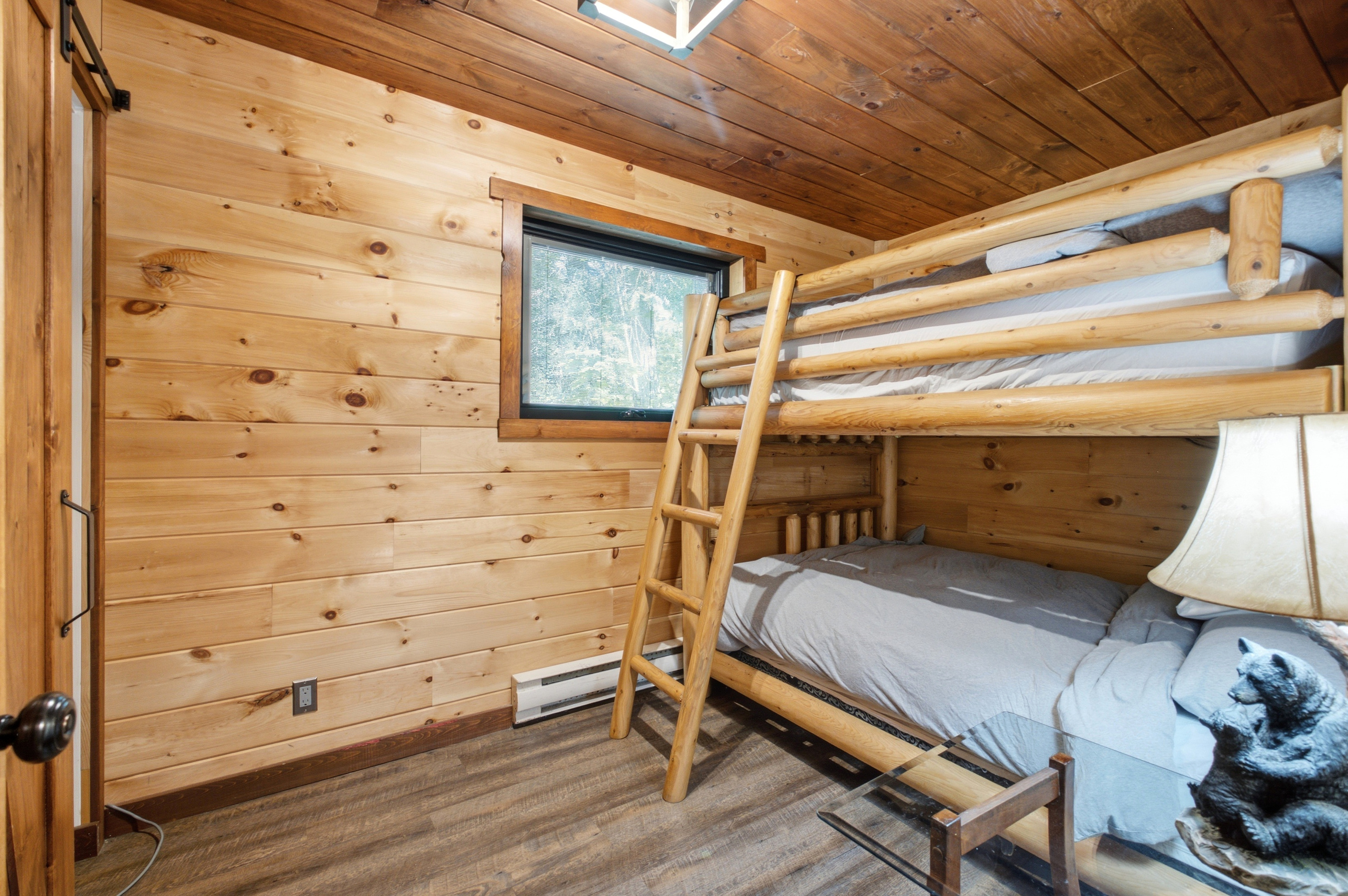 Bunk bedroom with rustic wood finishes and natural light