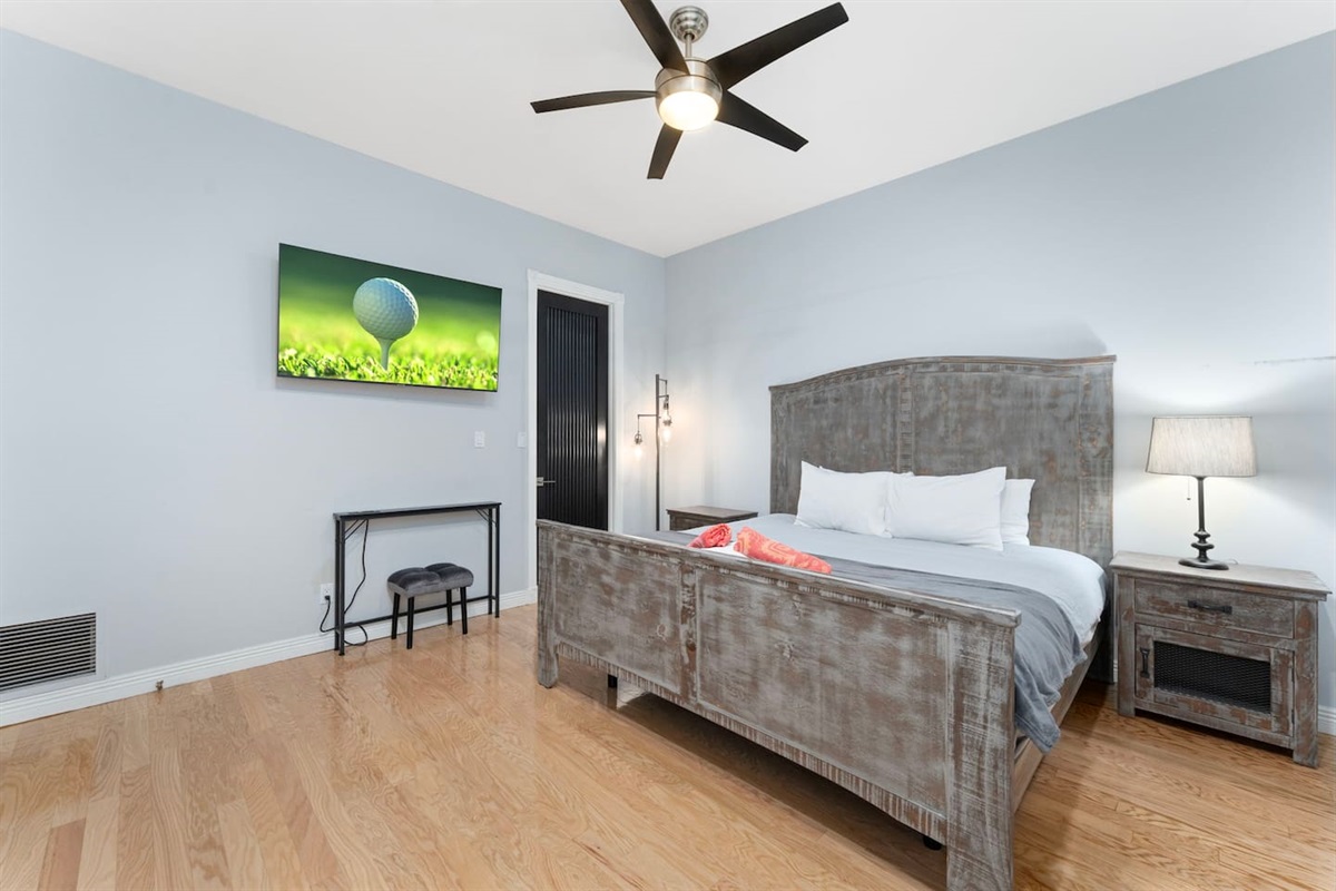 Unwind in this cozy king bedroom featuring rustic wood furnishings, soft linens, and warm ambient lighting.