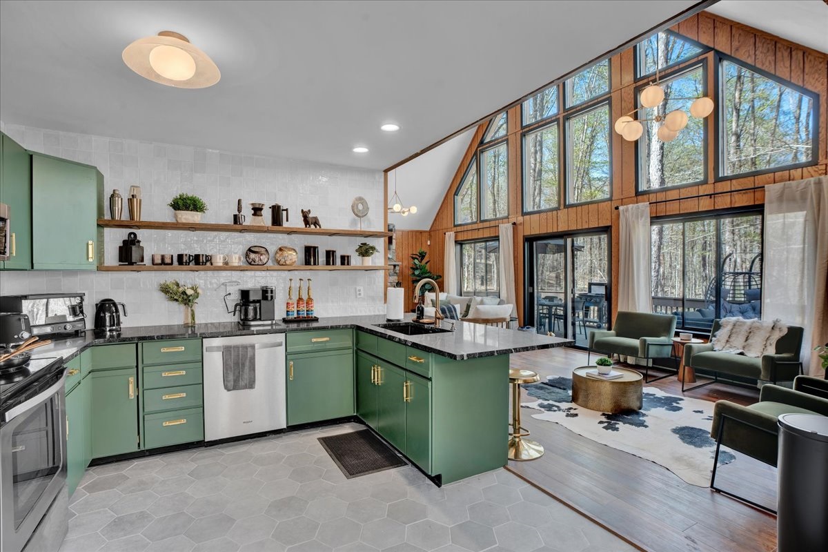 “Open-concept kitchen and living — cook, sip, and connect surrounded by forest views."