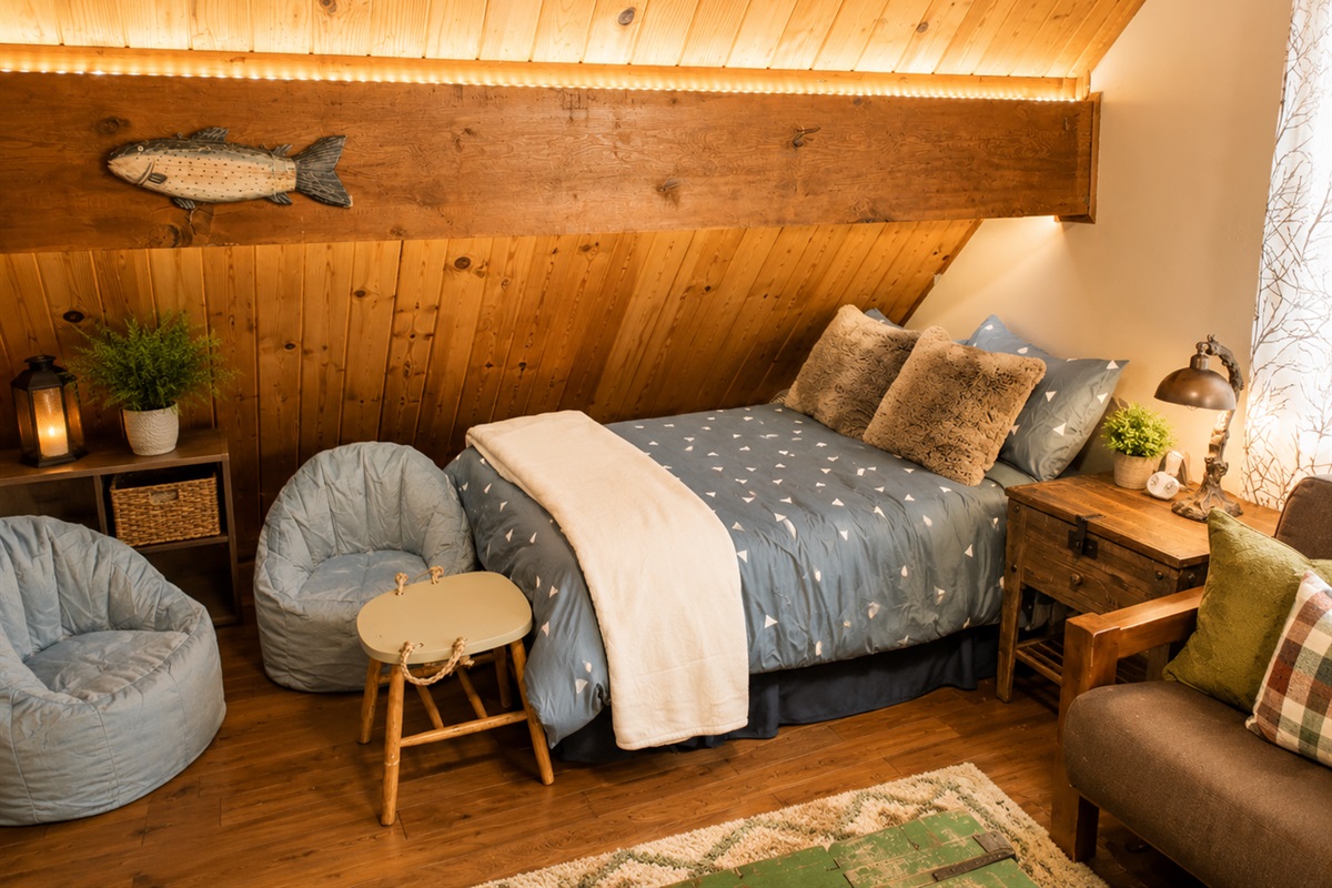 The upstairs loft area has 4 beds, a couch that folds into a futon bed and a couple bean bag chairs for the kids.  It also has a tv with cable, a mountain scene that is also chalk board and cozy mountain vibes.