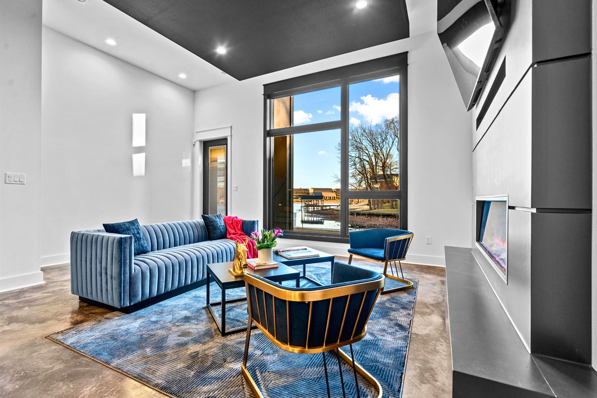 This inviting living room is the epitome of modern comfort, with plush seating, ample natural light, and chic decor that feels both stylish and cozy.