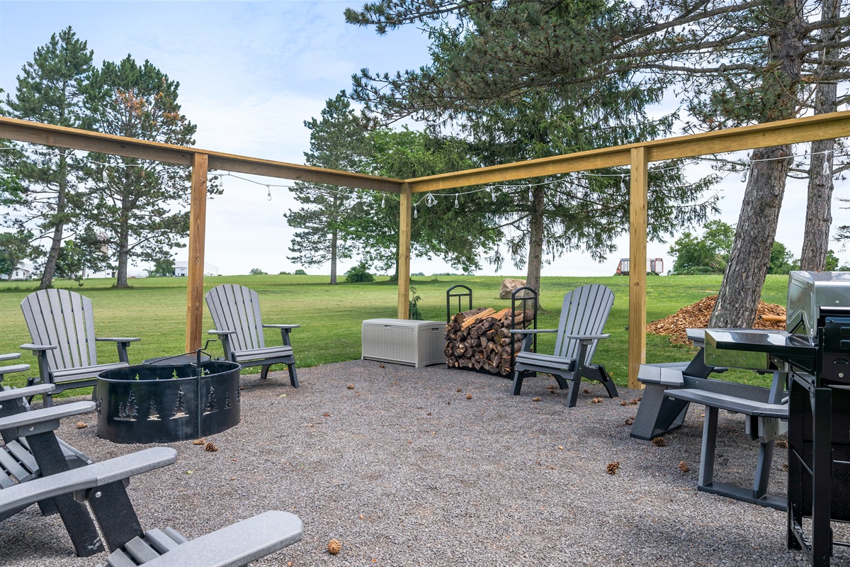 Cozy fire pit setup with ample seating, surrounded by serene greenery