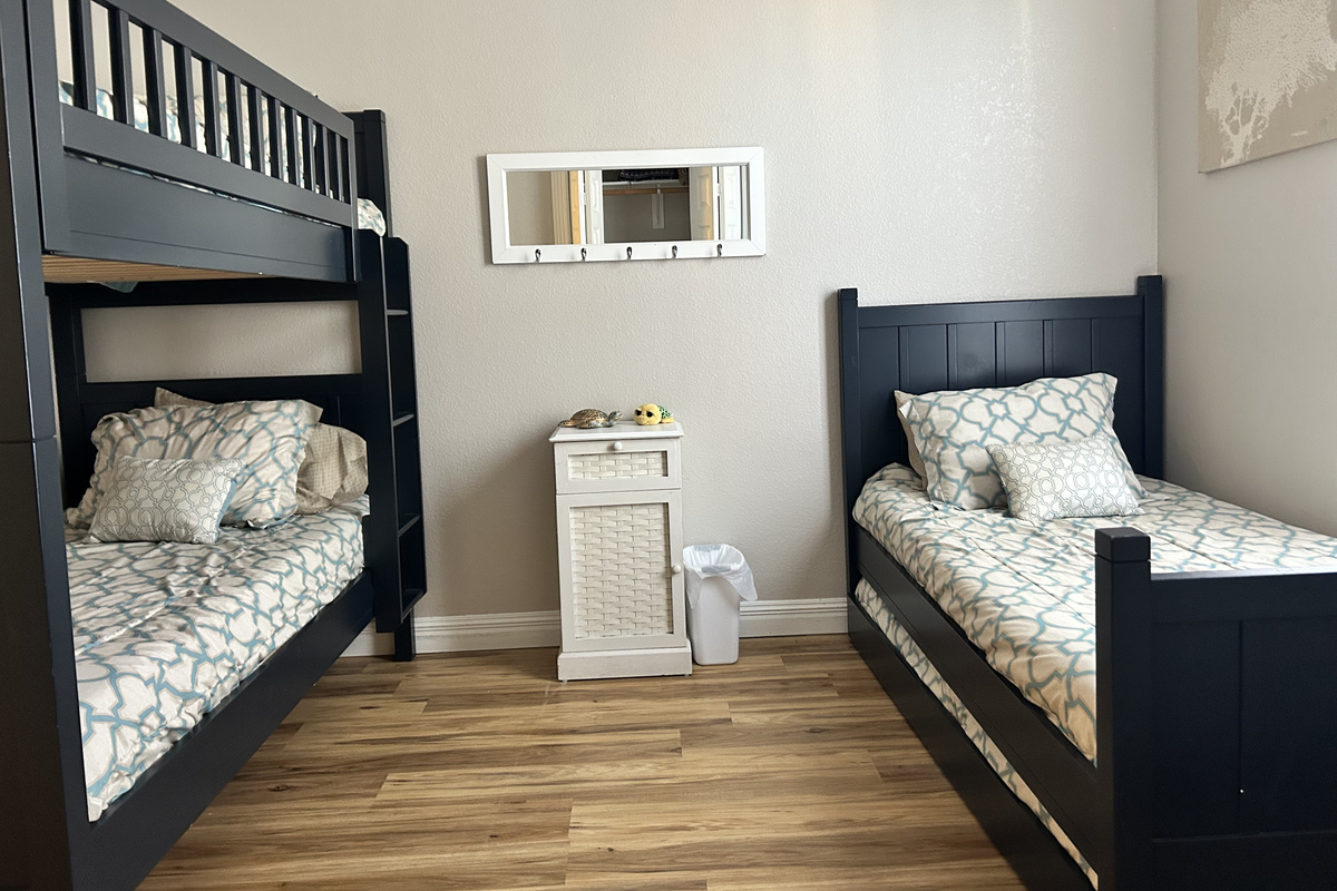 This bunk room sleeps up to 4 guests with a twin-over-twin bunk bed, plus a twin bed with a pullout trundle. Coastal-inspired décor, hardwood floors, and an HDTV make it the perfect retreat for kids or additional guests.