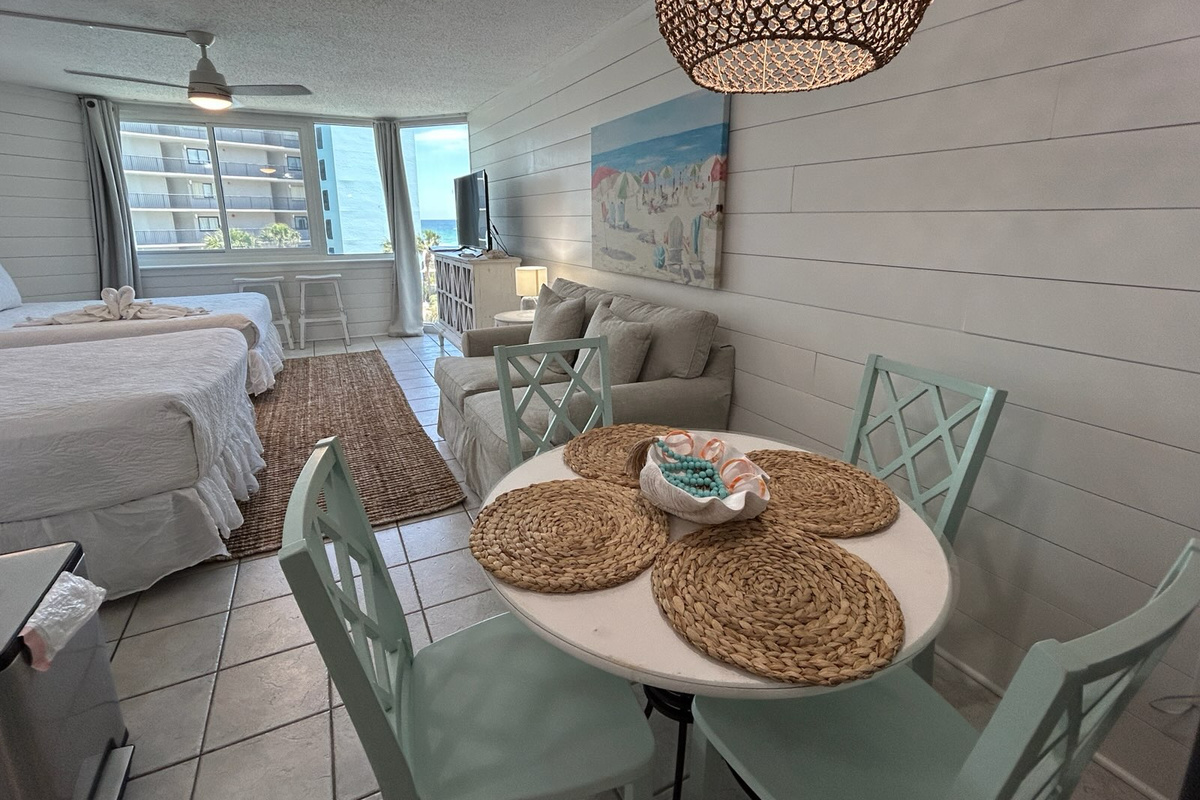 The open-concept layout offers a comfortable living area, dining space, two queen beds, and beautiful Gulf views—everything you need for a relaxing beachfront getaway.