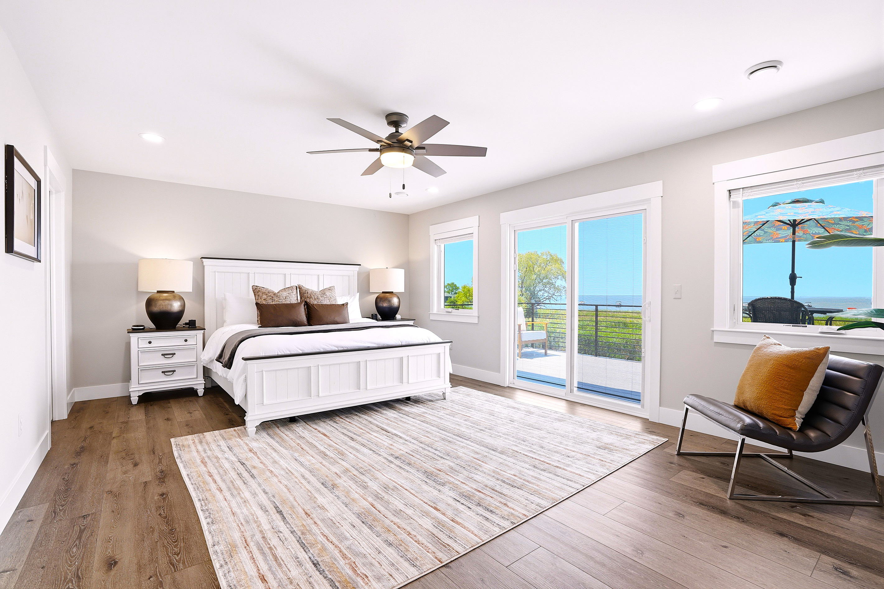 Retreat to the luxurious primary suite, where a plush king bed, private balcony, and sweeping views of Lake St. Clair create your own peaceful waterfront sanctuary.
