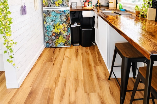 A charming kitchen features a refrigerator, freezer, microwave, toaster, drip-style coffee maker, electric kettle, and an indoor George Foreman grill. Bring your own crockpot, air fryer, or Instant Pot if you're planning a stay-at-home meal