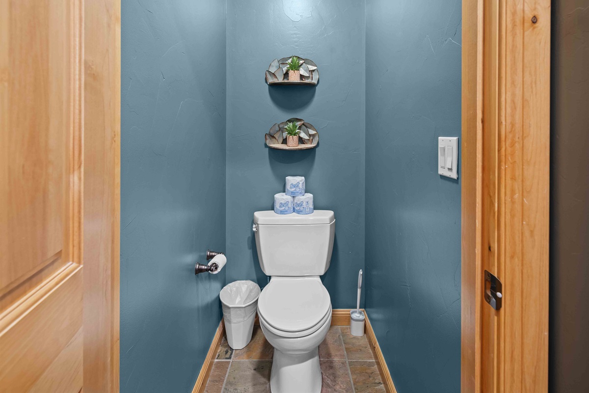 Separate toilet room with modern finishes for added convenience.
