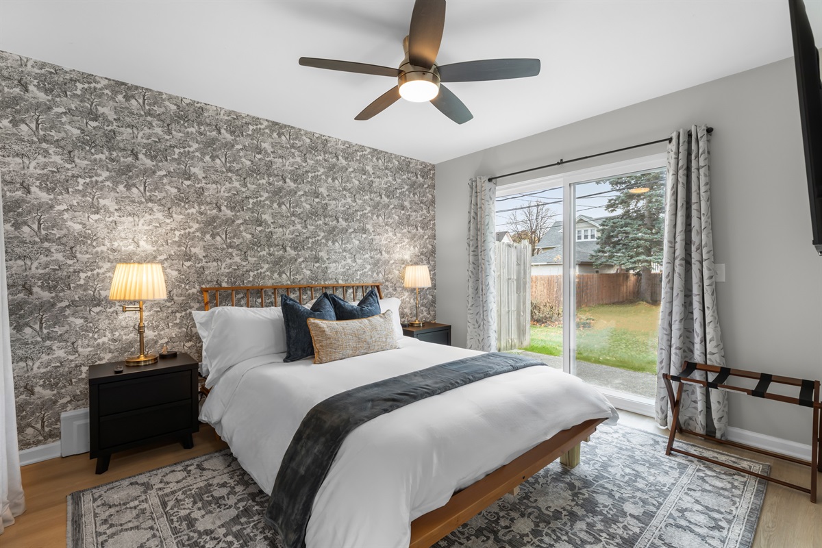 A stylish bedroom with a modern bed and a ceiling fan that adds a touch of elegance.