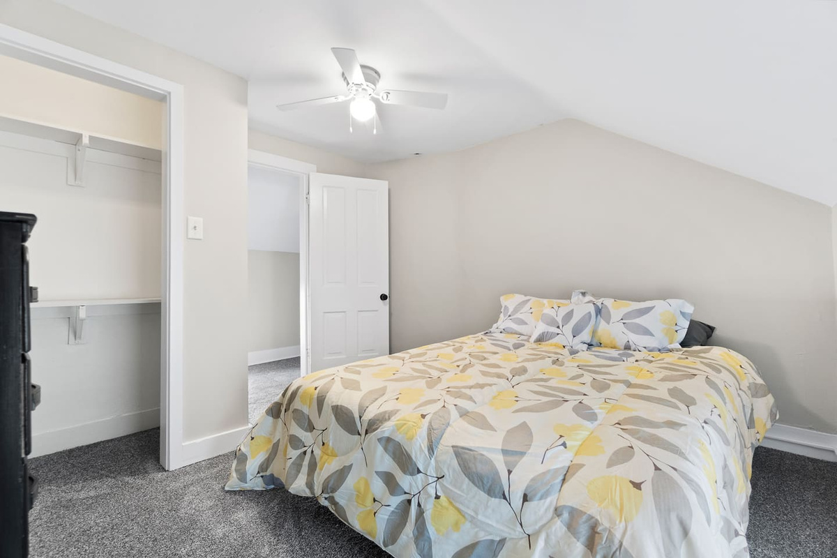 Bedroom with a queen-sized bed, complemented by a beautiful ceiling fan that adds both style and a cool breeze for ultimate comfort.