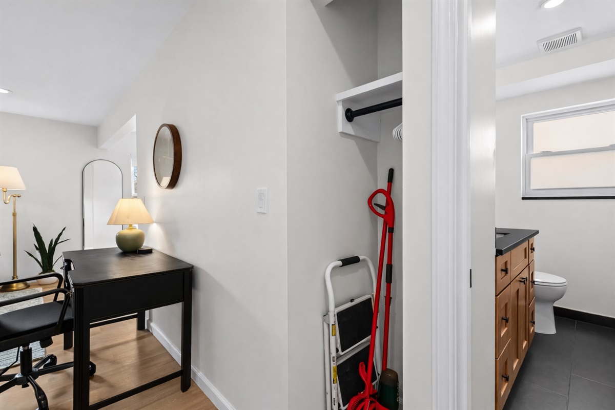 Convenient entry area with a tidy storage closet and nearby workspace, offering an organized, welcoming setup to settle in with ease.