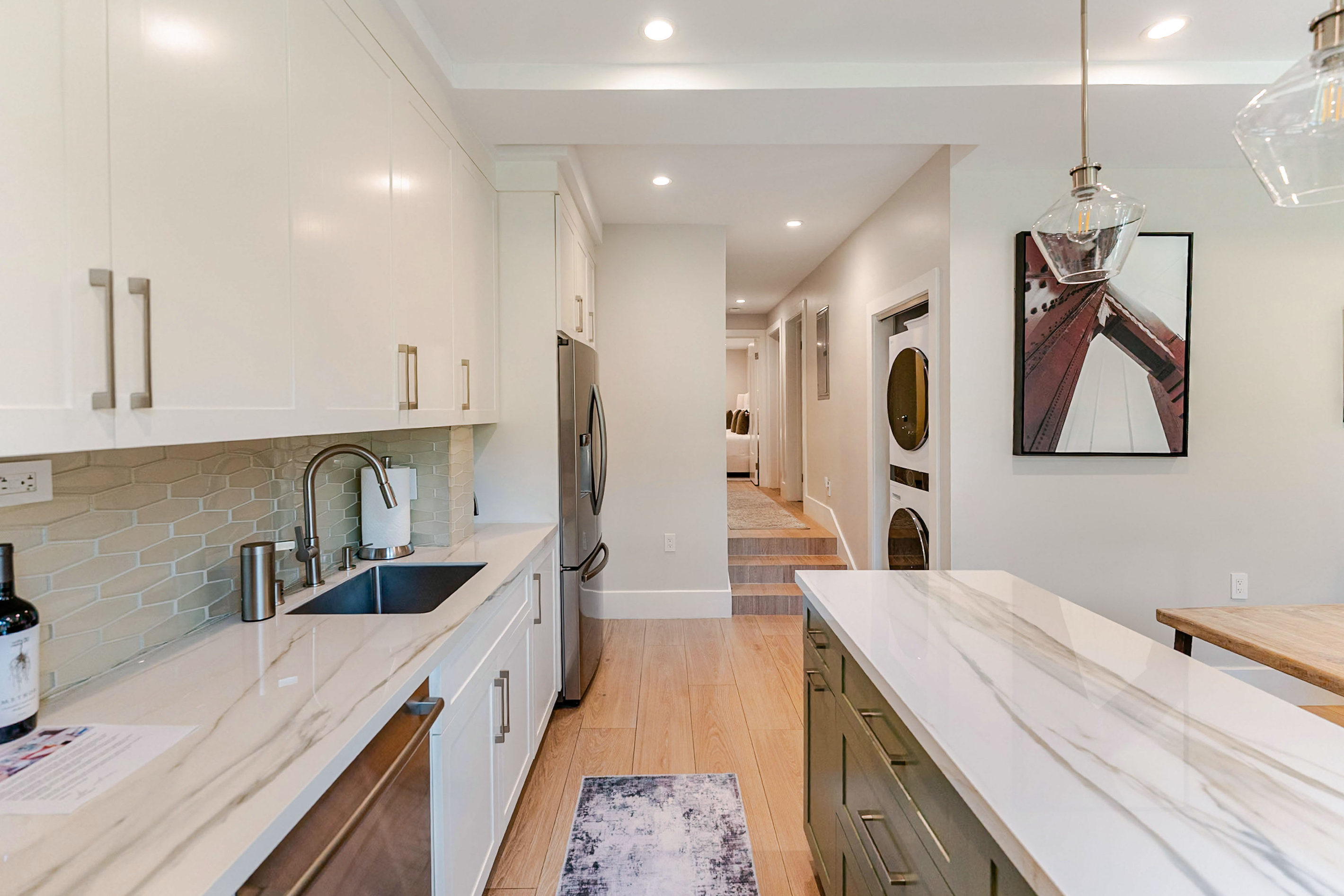 Fully-equipped chef's kitchen with counter and island stocked with cooking appliances and equipment and most everything needed for dining and drinking comfort.  