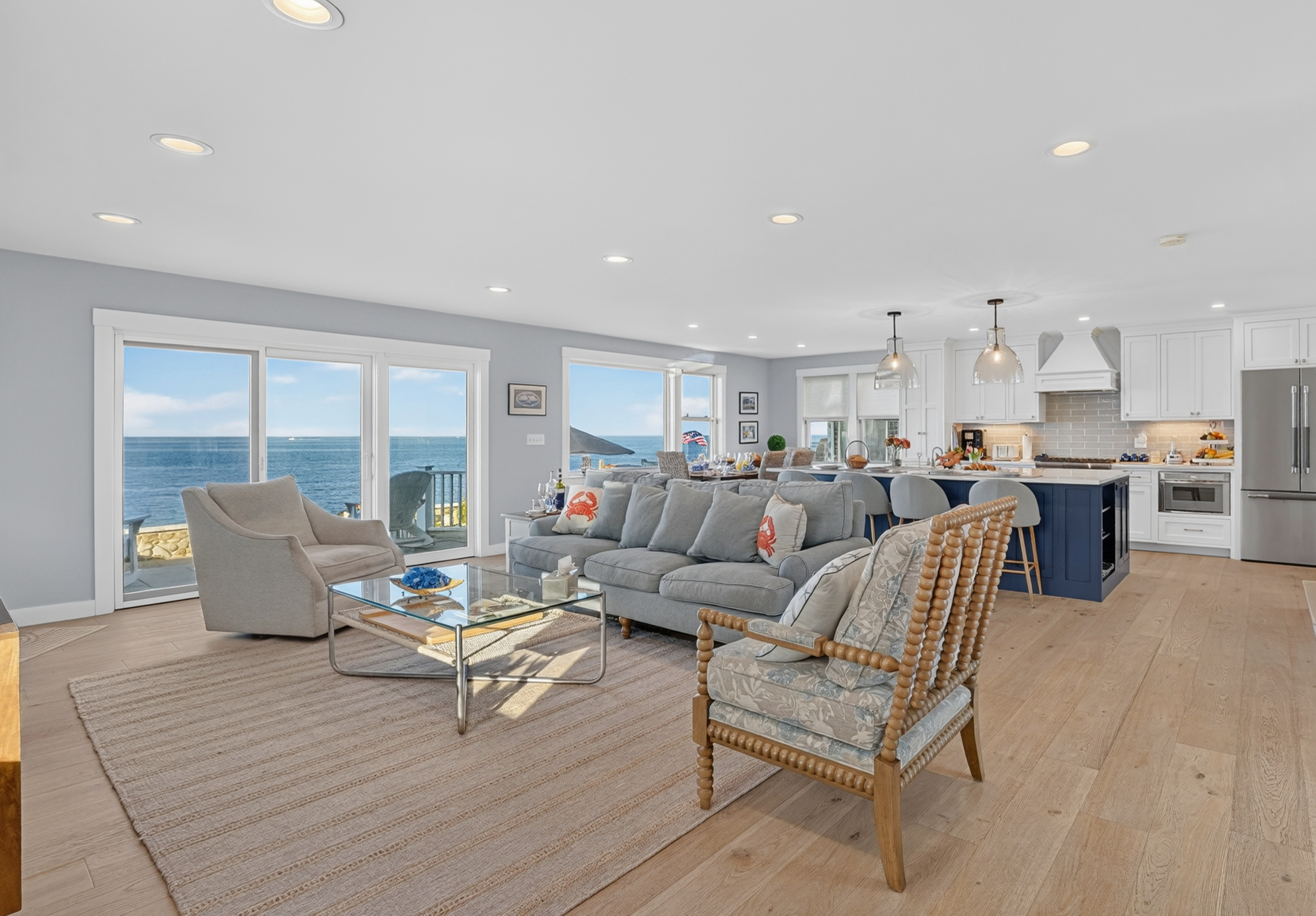 Bright open-concept living area with panoramic ocean views and seamless indoor-outdoor living