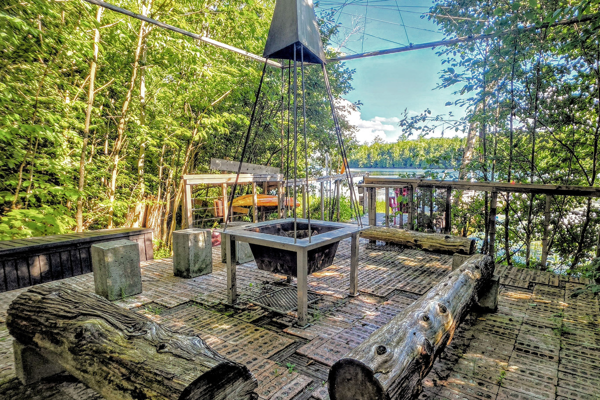 Seating around firepit near dock and edge of lake