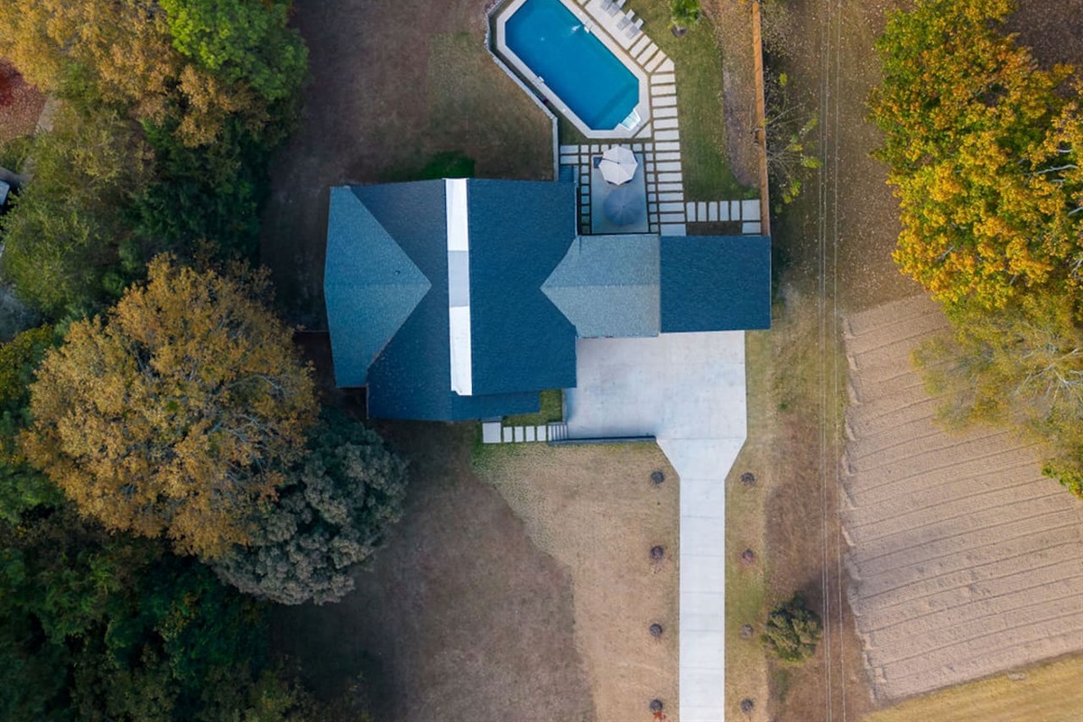 Stunning aerial view of the property, showcasing the spacious grounds, beautiful landscaping, and the perfect layout of the home in its surrounding environment.