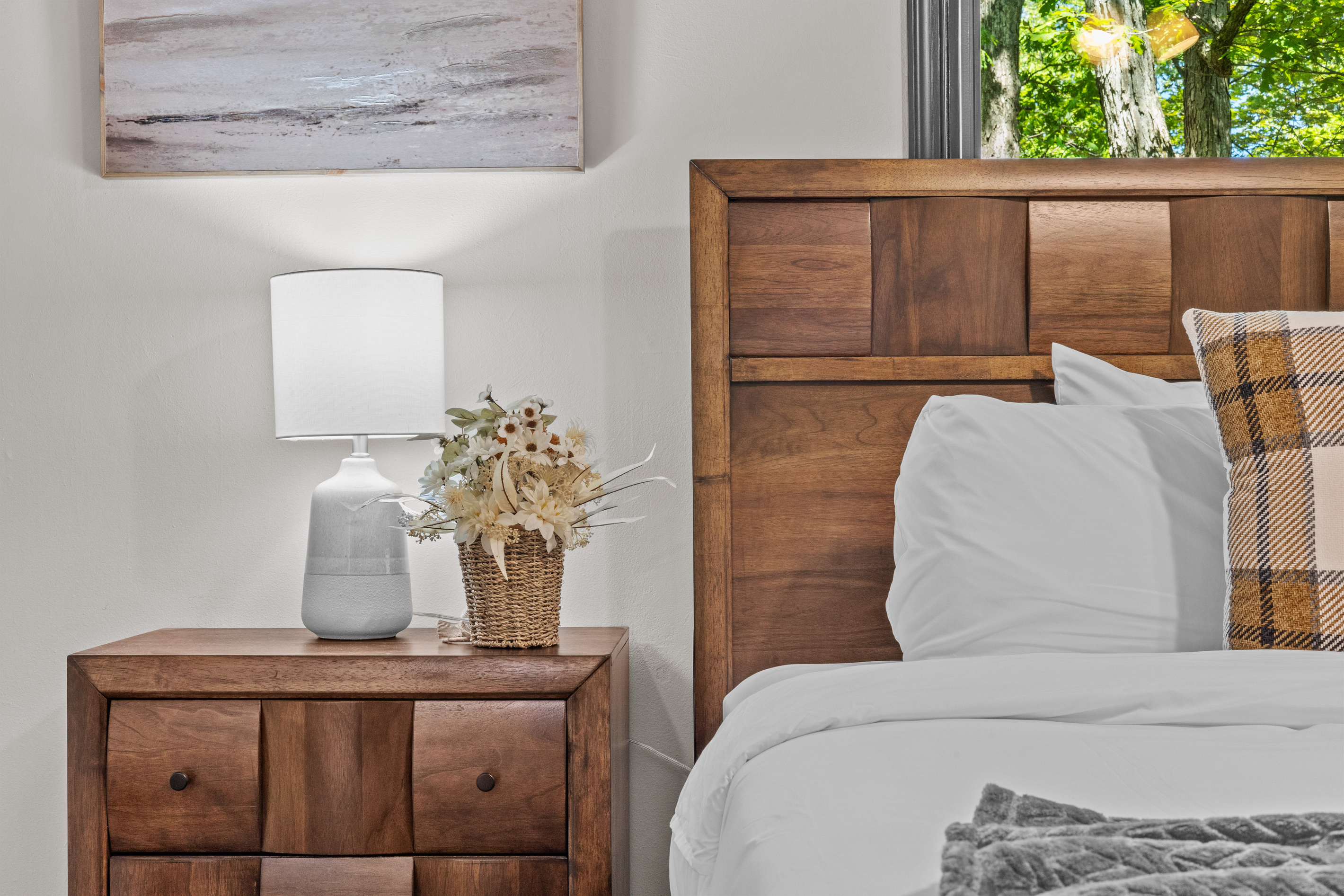 Large, sun-filled windows flood the bedroom with ample lighting