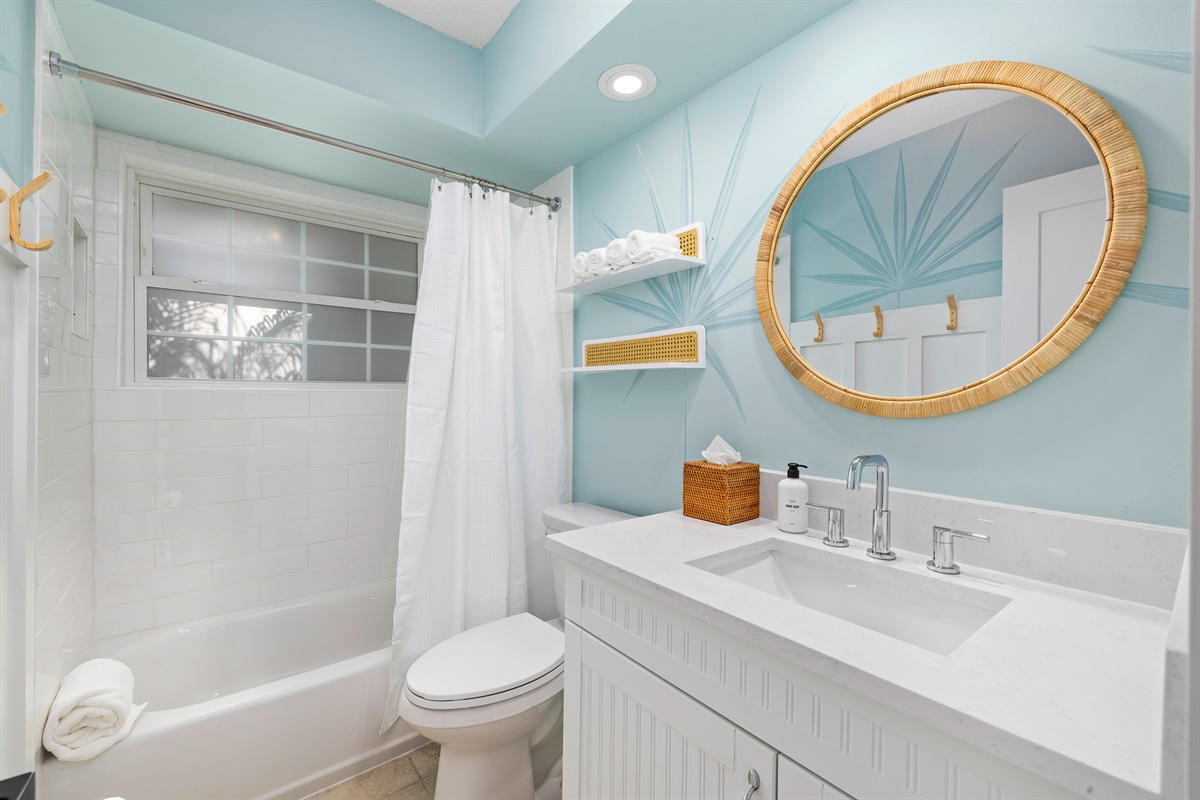 Shared guest hall bathroom with tub/shower combo and modern vanity
