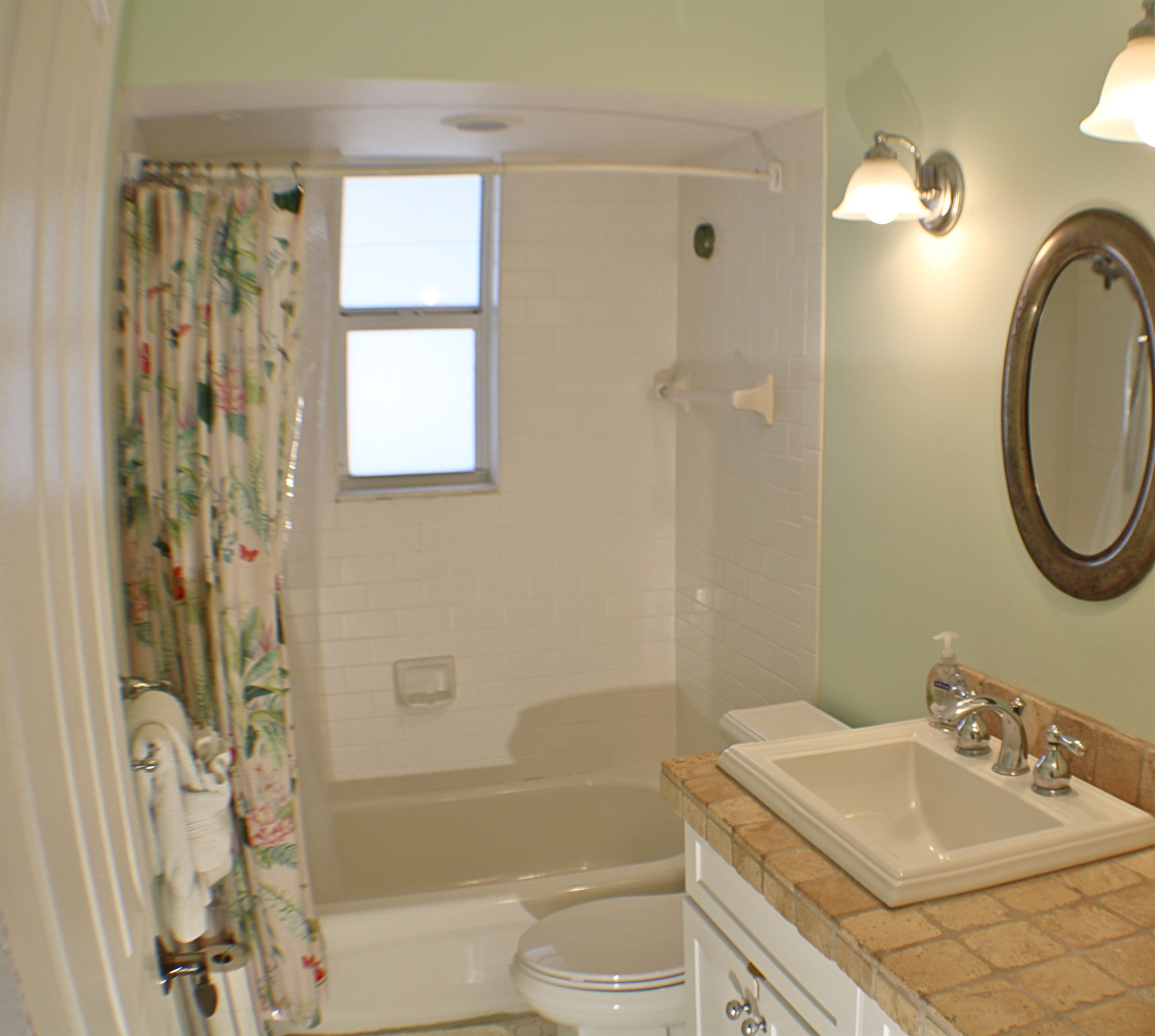 Guest bathroom features a tub and shower