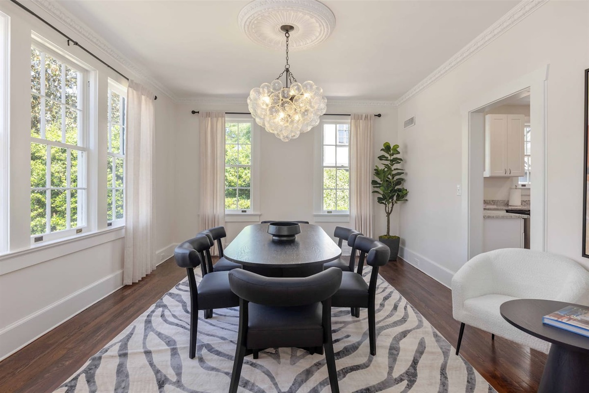 Gather around the dining table beneath a stunning bubble chandelier in this bright, modern dining room — with seating for eight.