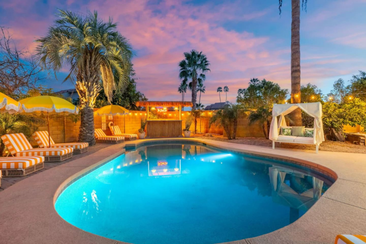 Resort-style pool at sunset with loungers, umbrellas, and desert views—your private oasis for swimming and stargazing.