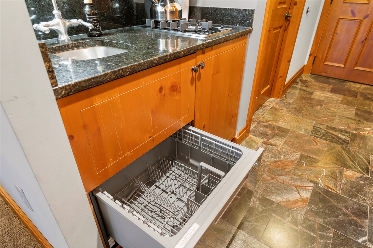 The kitchenette is equipped with a stove-top, microwave, dishwasher and refrigerator for your convenience